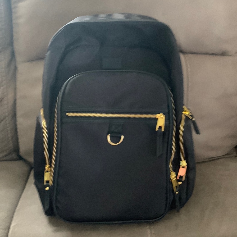 East sports black backpack Gold zippers You can put your wardrobe in it